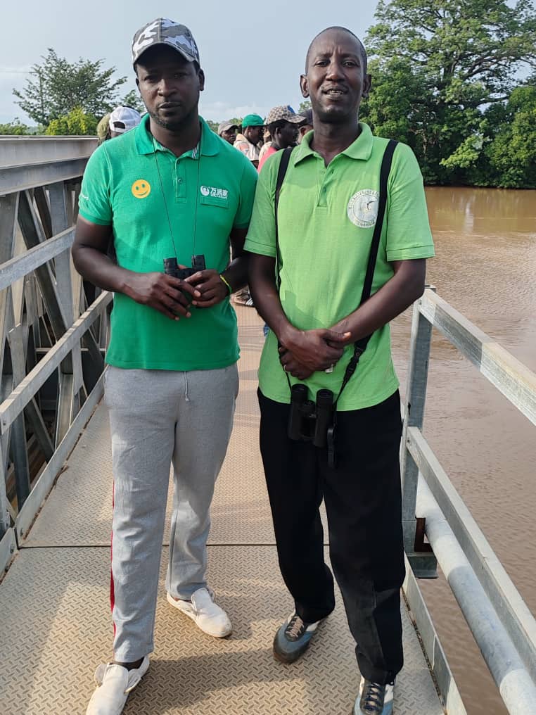 Assan with a guest birder smiling at camp